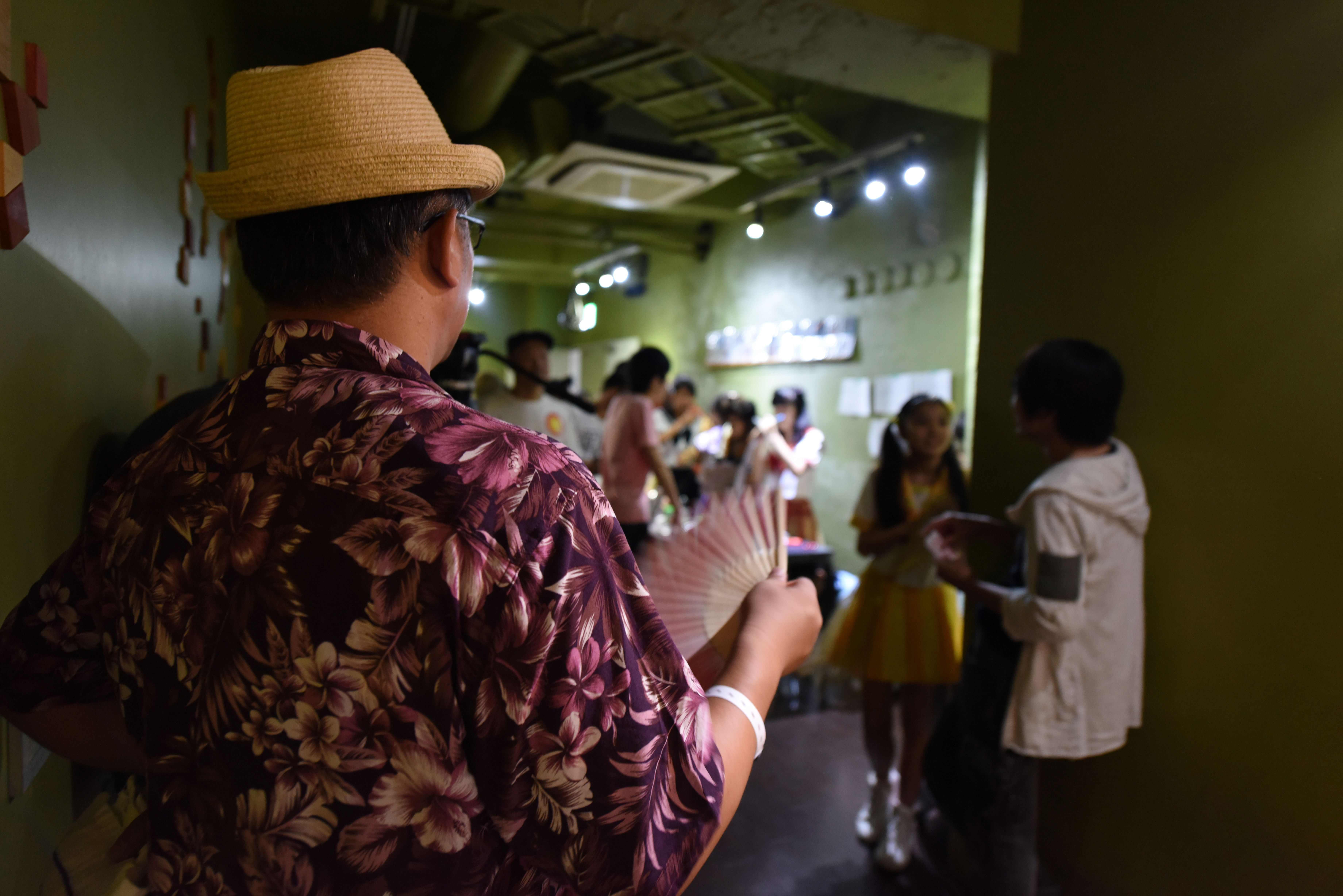 A man looks at an idol singer at a concert in Tokyo on July 29, 2017.